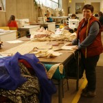 Piles of fabric are measured for upcoming shows.